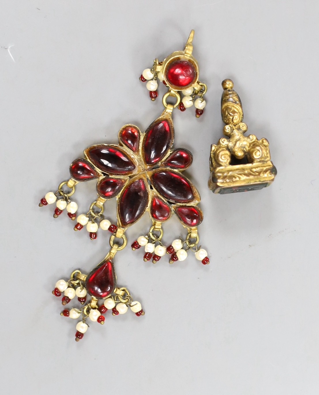 A gilt metal and bloodstone set fob seal, 30mm and a gilt metal, red paste and simulated seed pearl set drop pendant.